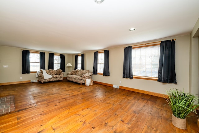 unfurnished living room with recessed lighting, visible vents, baseboards, and light wood-style flooring