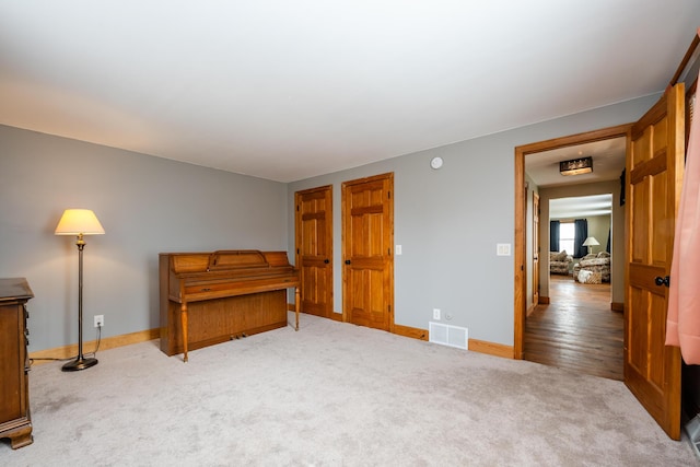 carpeted bedroom featuring visible vents and baseboards