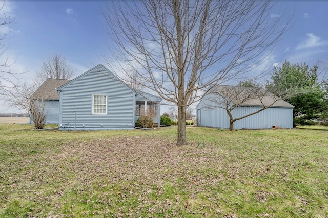 view of property exterior featuring an outbuilding, a lawn, and an outdoor structure
