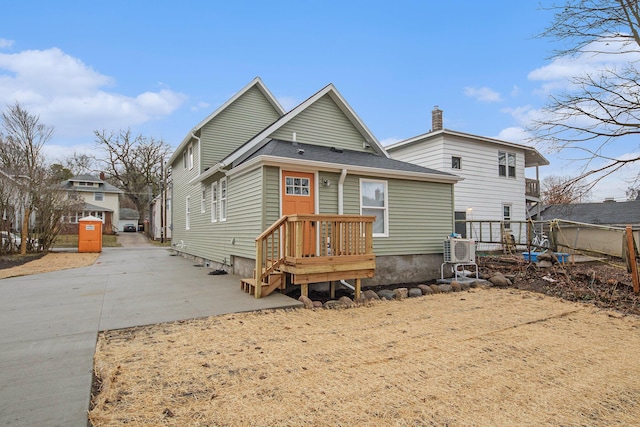 609 Lincoln Ave NW, Grand Rapids, MI 49504 - rear view of house featuring a chimney