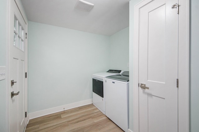 609 Lincoln Ave NW, Grand Rapids, MI 49504 - washroom with washing machine and dryer and light wood-type flooring