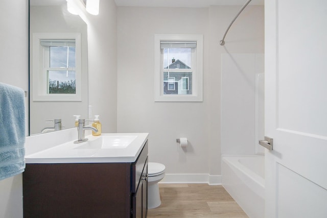 609 Lincoln Ave NW, Grand Rapids, MI 49504 - full bathroom featuring vanity, wood finished floors, healthy amount of natural light, and shower / bathtub combination