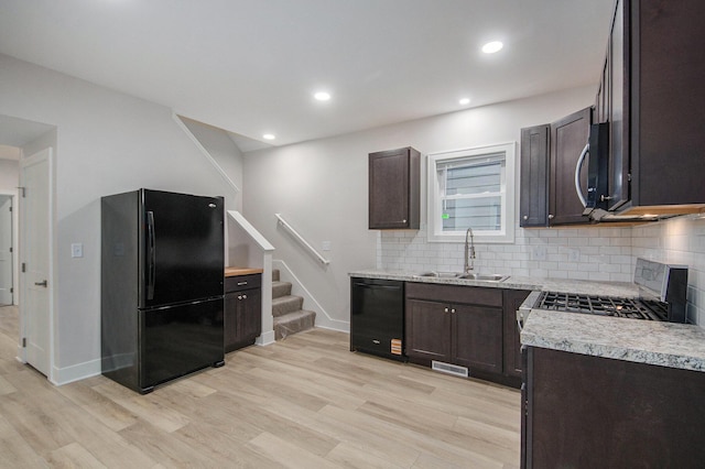 609 Lincoln Ave NW, Grand Rapids, MI 49504 - kitchen featuring black appliances, light wood-style flooring, dark brown cabinets, decorative backsplash, and recessed lighting