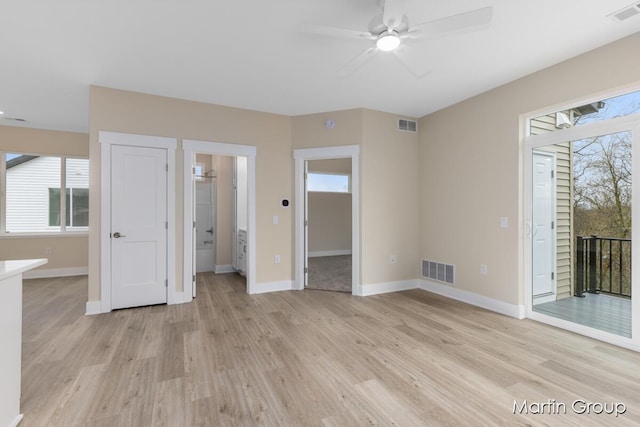 interior space featuring light wood finished floors, visible vents, and ceiling fan