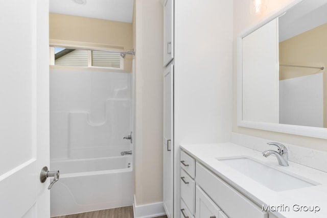 full bath with shower / bathtub combination, wood finished floors, and vanity