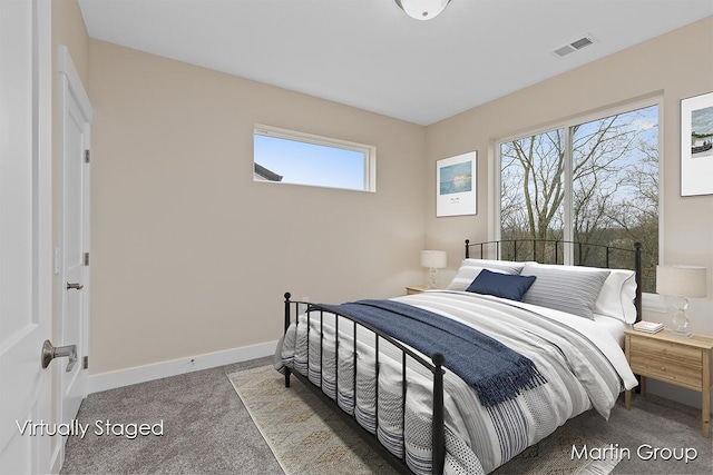 bedroom featuring visible vents, baseboards, and carpet