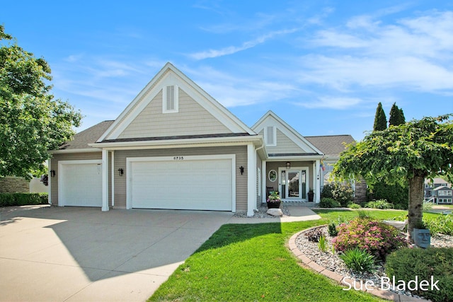 6735 Windflower Way, Norton Shores, MI 49444 - view of front of home featuring a garage, driveway, and a front yard