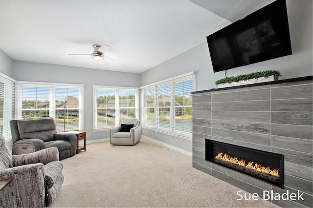 6735 Windflower Way, Norton Shores, MI 49444 - living room featuring a tiled fireplace, carpet floors, and ceiling fan