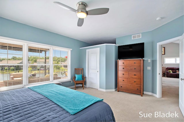 6735 Windflower Way, Norton Shores, MI 49444 - bedroom with light carpet, multiple windows, and a ceiling fan