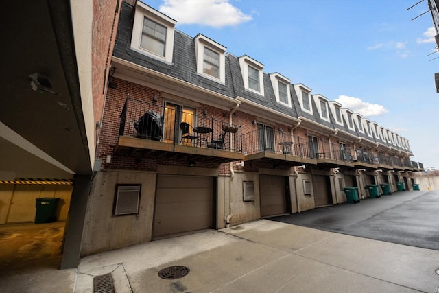 view of property featuring driveway and a garage
