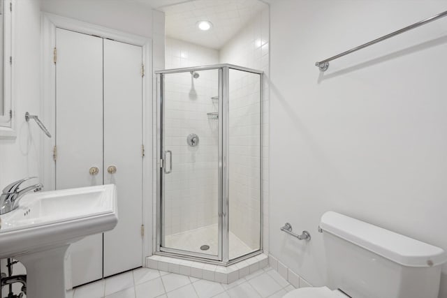 full bathroom with toilet, a stall shower, and tile patterned floors