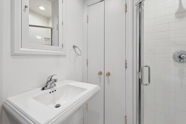 bathroom featuring a sink and a stall shower