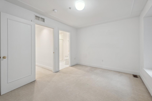 unfurnished bedroom with light carpet, baseboards, and visible vents
