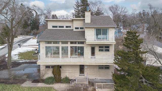 2019 Silvertip Ln, Long Beach, IN 46360 - back of property with a balcony, roof with shingles, and a chimney