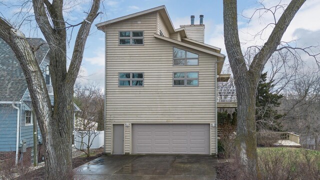 2019 Silvertip Ln, Long Beach, IN 46360 - back of property featuring fence, a garage, and a chimney