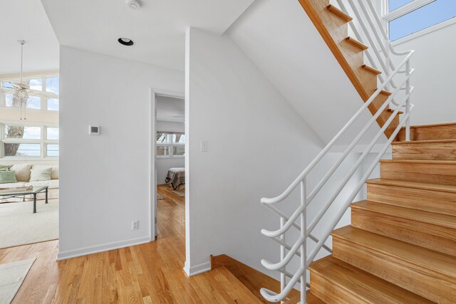 2019 Silvertip Ln, Long Beach, IN 46360 - stairs featuring baseboards, a ceiling fan, and wood finished floors