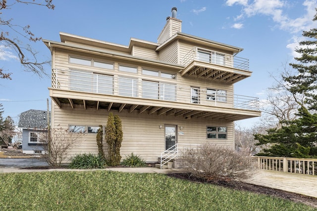 2019 Silvertip Ln, Long Beach, IN 46360 - view of front of home with a front lawn, a balcony, and a chimney