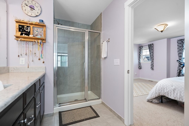 6337 S Trailwoods Dr, Ann Arbor, MI 48103 - ensuite bathroom with a stall shower, baseboards, vanity, and tile patterned flooring