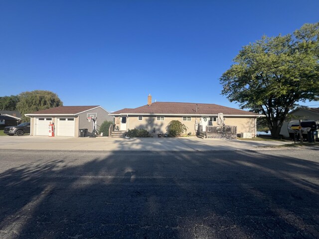 2772 S Wisner Ave, Fremont, MI 49412 - view of front of property featuring a garage and a chimney