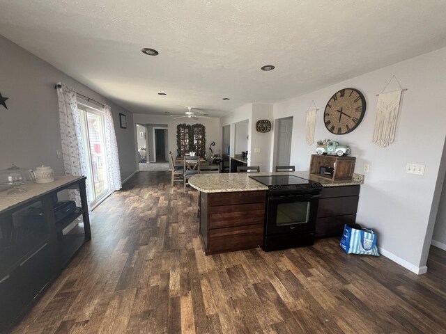 2772 S Wisner Ave, Fremont, MI 49412 - kitchen featuring dark wood finished floors, electric range, dark brown cabinets, and baseboards