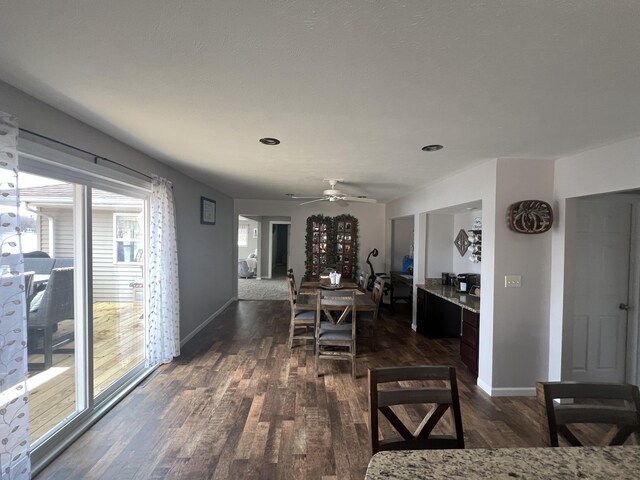 2772 S Wisner Ave, Fremont, MI 49412 - dining room with dark wood-style floors, baseboards, and ceiling fan