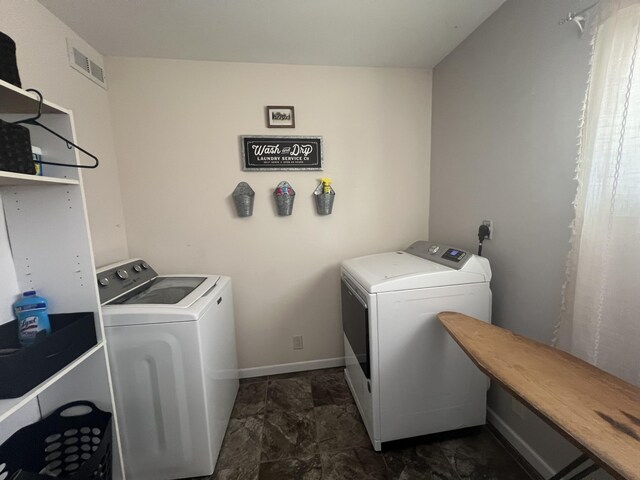 2772 S Wisner Ave, Fremont, MI 49412 - clothes washing area with laundry area, baseboards, visible vents, and washing machine and clothes dryer
