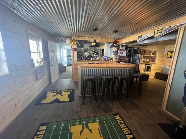 2772 S Wisner Ave, Fremont, MI 49412 - interior space featuring a bar, wood finished floors, and wood walls