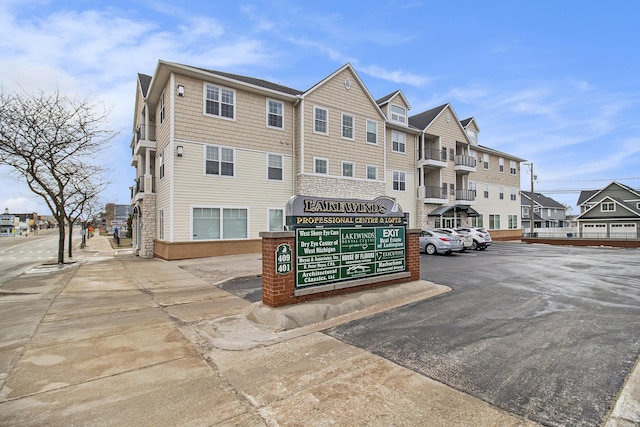 401 W Ludington Ave Unit 208, Ludington, MI 49431 - view of building exterior featuring uncovered parking