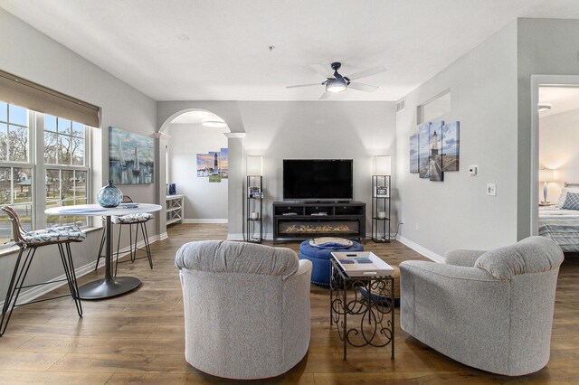 401 W Ludington Ave Unit 208, Ludington, MI 49431 - living room featuring arched walkways, baseboards, a ceiling fan, and wood finished floors