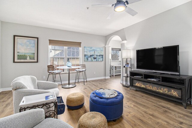 401 W Ludington Ave Unit 208, Ludington, MI 49431 - living room featuring baseboards, arched walkways, wood finished floors, and a ceiling fan