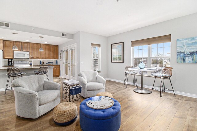 401 W Ludington Ave Unit 208, Ludington, MI 49431 - living room with light wood-style flooring, visible vents, and baseboards