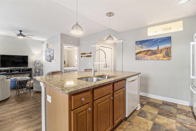 401 W Ludington Ave Unit 208, Ludington, MI 49431 - kitchen featuring brown cabinetry, a ceiling fan, white dishwasher, a sink, and hanging light fixtures