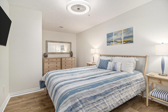 401 W Ludington Ave Unit 208, Ludington, MI 49431 - bedroom with visible vents, baseboards, and wood finished floors
