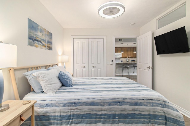 401 W Ludington Ave Unit 208, Ludington, MI 49431 - bedroom featuring a closet, baseboards, and a sink