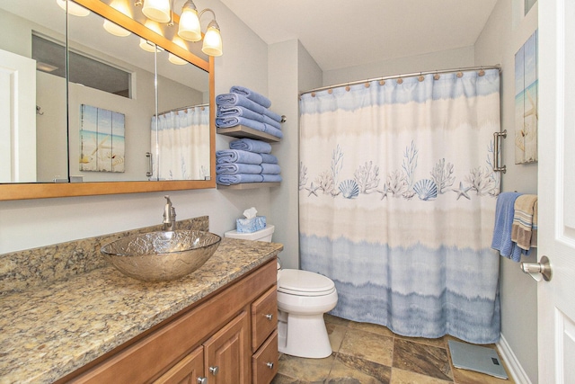 401 W Ludington Ave Unit 208, Ludington, MI 49431 - bathroom with vanity, toilet, a shower with curtain, and stone finish flooring