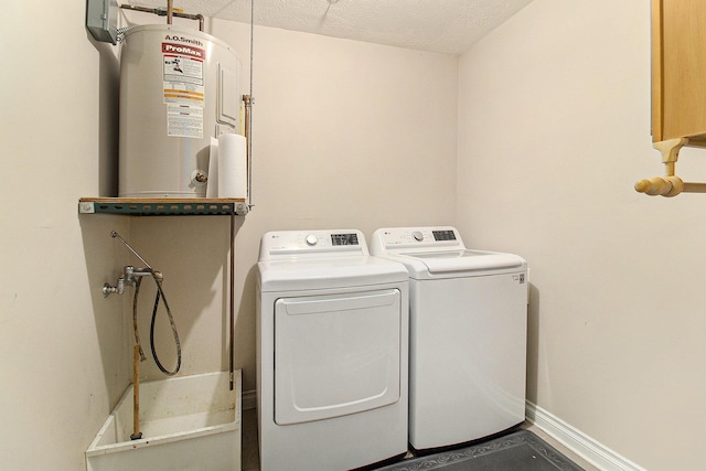401 W Ludington Ave Unit 208, Ludington, MI 49431 - laundry room featuring baseboards, water heater, laundry area, independent washer and dryer, and a textured ceiling