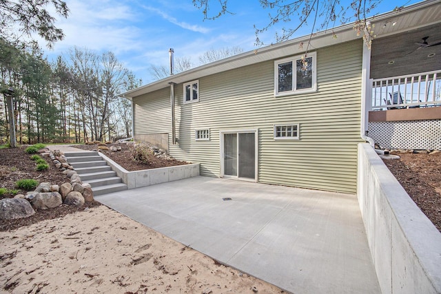 back of house featuring stairs and a patio area