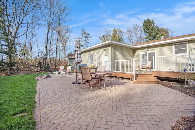 view of patio with outdoor dining space and a wooden deck