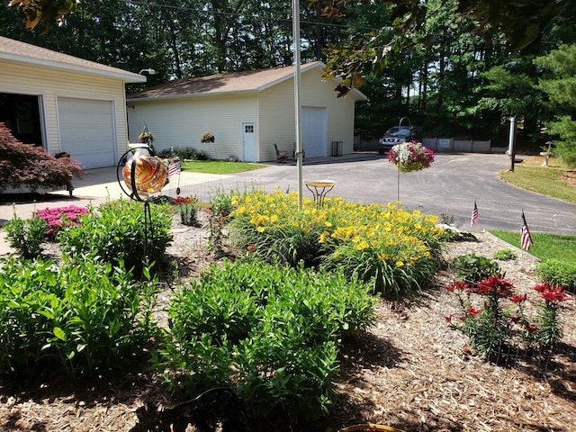 view of home's exterior with an outdoor structure and a garage