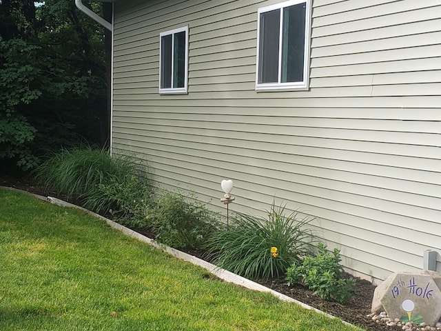 view of home's exterior featuring a lawn