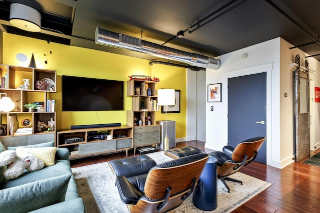 living area with baseboards and hardwood / wood-style flooring