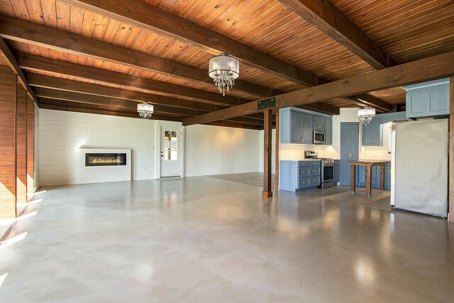 426 Elizabeth St, Buchanan, MI 49107 - basement featuring freestanding refrigerator, a notable chandelier, a glass covered fireplace, and wooden ceiling