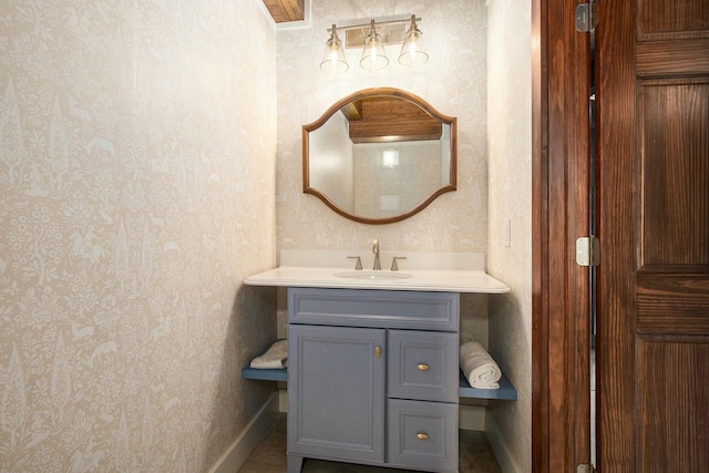 426 Elizabeth St, Buchanan, MI 49107 - bathroom with wallpapered walls, vanity, and baseboards