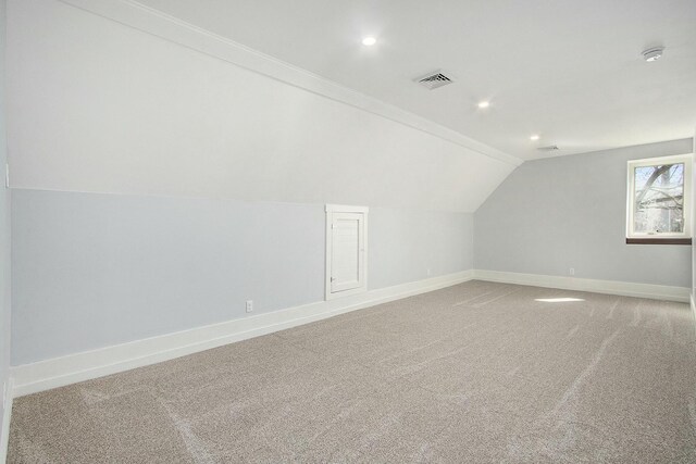 426 Elizabeth St, Buchanan, MI 49107 - additional living space with light carpet, baseboards, lofted ceiling, and visible vents