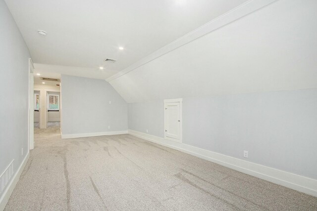 426 Elizabeth St, Buchanan, MI 49107 - additional living space featuring baseboards, lofted ceiling, visible vents, and light colored carpet