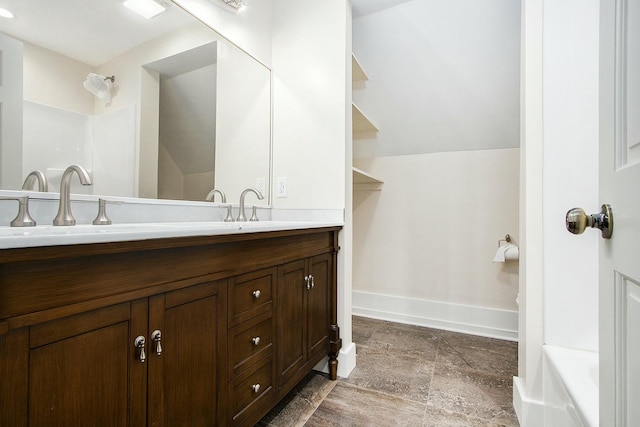 426 Elizabeth St, Buchanan, MI 49107 - bathroom with double vanity, baseboards, a sink, and walk in shower