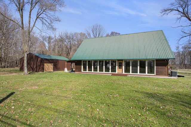 426 Elizabeth St, Buchanan, MI 49107 - rear view of property with central AC unit, a yard, and metal roof