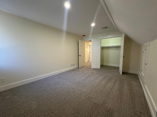 426 Elizabeth St, Buchanan, MI 49107 - unfurnished bedroom featuring baseboards, lofted ceiling, a closet, and carpet