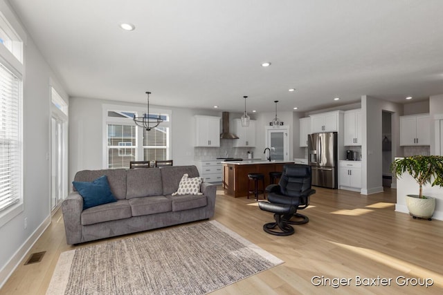 5560 Albright Ave SW Unit 67, Wyoming, MI 49418 - living area featuring visible vents, baseboards, recessed lighting, light wood-style floors, and a notable chandelier