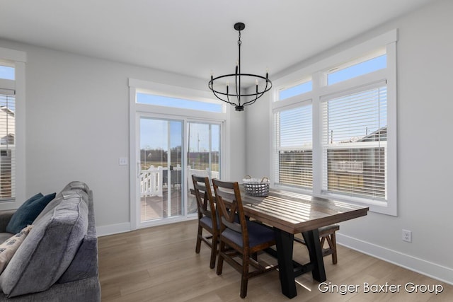 5560 Albright Ave SW Unit 67, Wyoming, MI 49418 - dining space with a notable chandelier, baseboards, and light wood-type flooring
